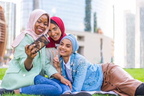 Preview: Beautiful muslim girl wearing hijab bonding outdoors