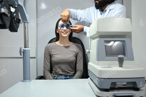 Preview: Ophthalmologist testing vision or sight of female patient for glasses in a clinic.