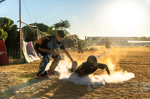 Preview: Kids playing baseball sliding into base at sunset