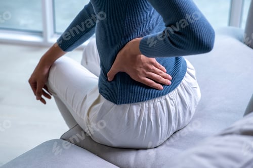 Preview: Female with back pain at home