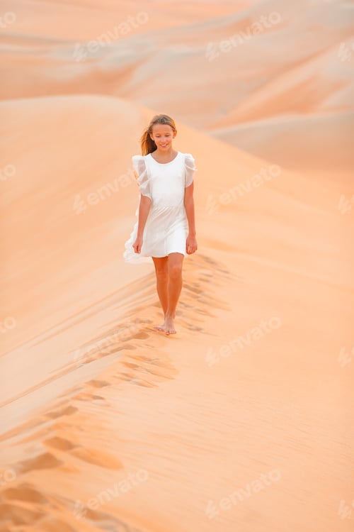 Preview: Girl among dunes in desert in United Arab Emirates