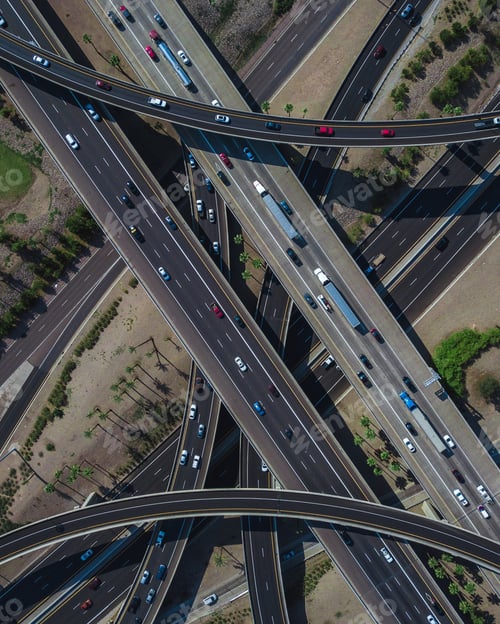 Preview: Overhead drone shot of a busy highway intersection full of traffic during daytime
