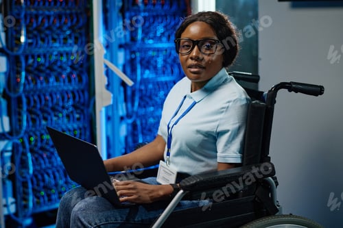 Preview: Female IT engineer with disability working on laptop