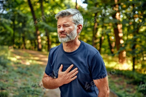 Preview: A Man Experiencing Discomfort and Unease While Being Outdoors in the Lush Greenery