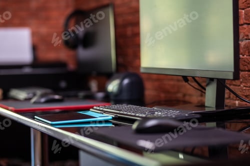 Preview: Two computer monitors with black screen on a desk, one workplace on table for two people