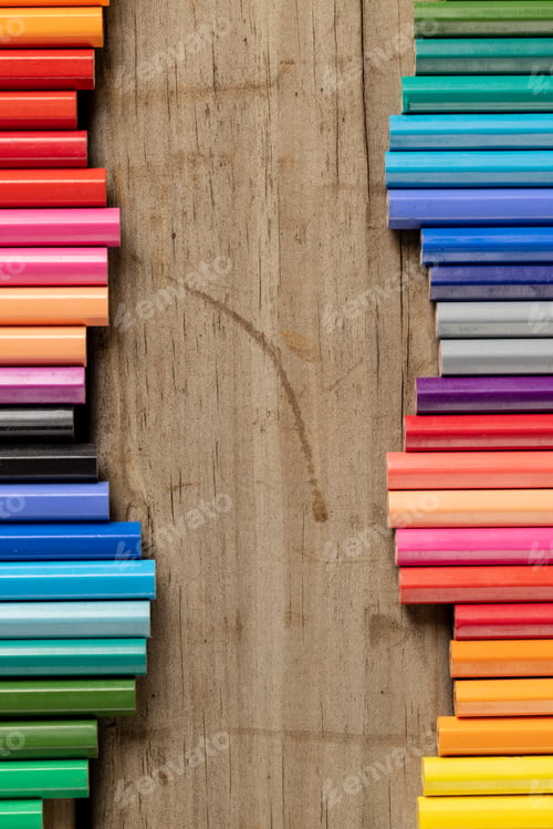 Preview: Vertical composition of colorful crayons on wooden background