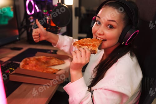 Preview: Smiling young woman gmaer in headphones