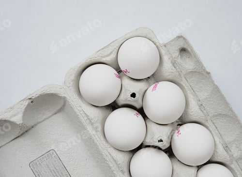 Preview: White Eggs in an Open Carton on White