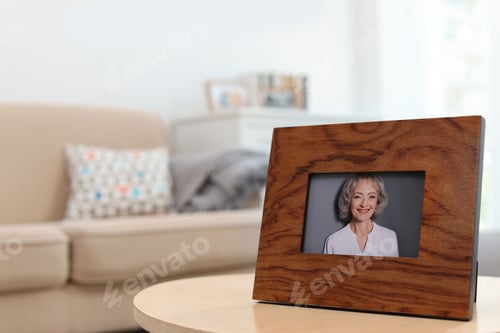 Preview: Framed portrait of senior woman on table indoors. Space for text