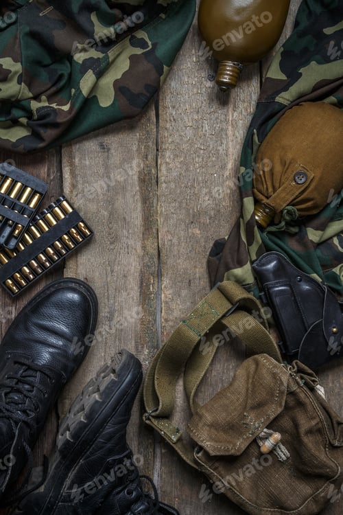 Preview: Army military uniform, weapon, holster, pistol, flask, boots on wooden background. Flat lay top view