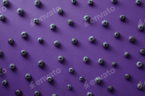 Preview: pattern of ripe blueberries on violet surface