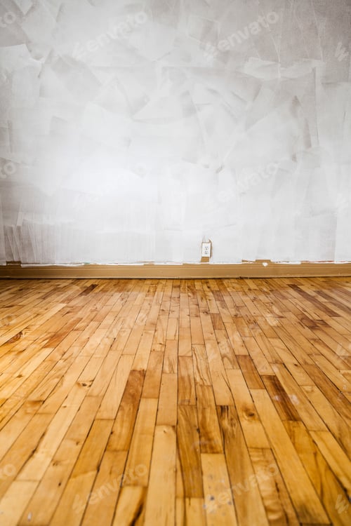 Empty room with newly plastered white wall