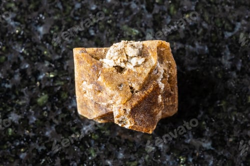 Preview: sample of raw zircon crystal on black granite
