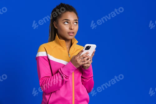 Preview: Young Woman with Mobile Phone on Blue Background