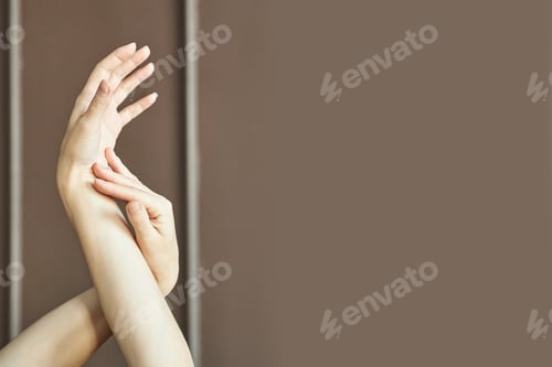 Preview: Graceful hands posed against brown background with neutral tones and soft light