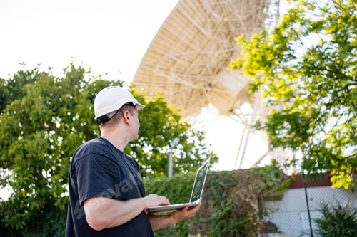 Preview: Engineer looking earth based astronomical radio telescope