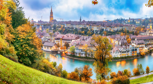 Preview: Fabulous autumn view of Bern city on Aare river during evening with Cathedral of Bern on background