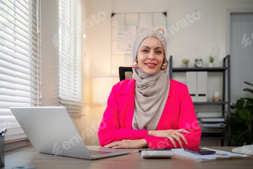 Preview: Muslim business woman hijab working about financial with business report and calculator on laptop
