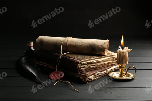 Preview: Old rolled scroll, burning candle, feather and books on black wooden table