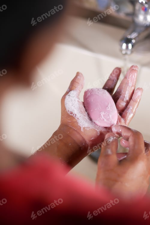 Preview: young man washing hands with soap warm water