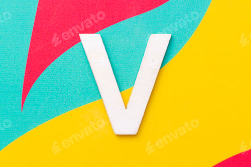 Preview: Letter V of the alphabet on colored background, top view