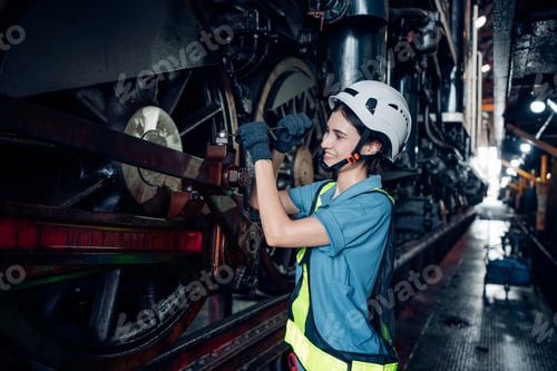 Preview: Portrait of female engineer working and looking camera in industrial factory.