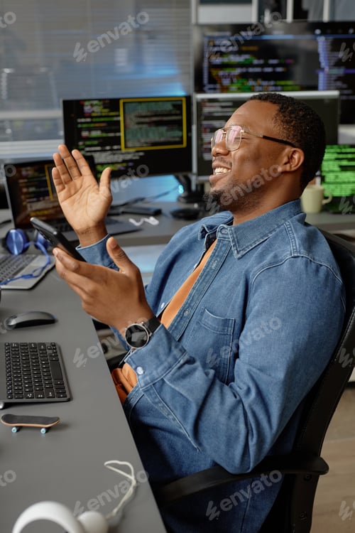 Preview: Smiling Black Male Programmer Joyfully Clapping Hands