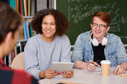 Preview: Cheerful girl and her groupmate listening to one of guys during discussion