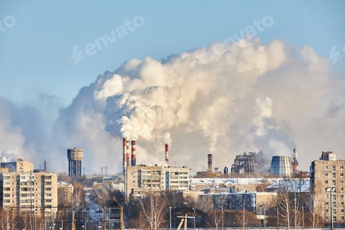 Preview: Thick smoke rises from factories in city. Industrial structures stand alongside residential