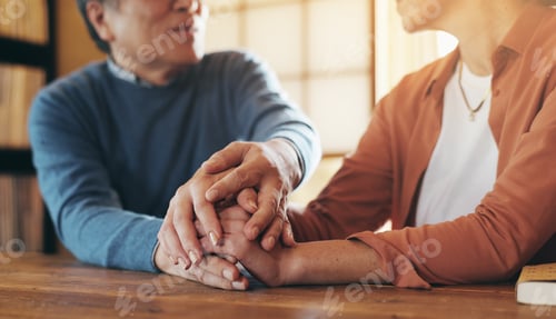Preview: Couple, holding hands and empathy in home for help, support or hope in Japan. Mature man, woman and