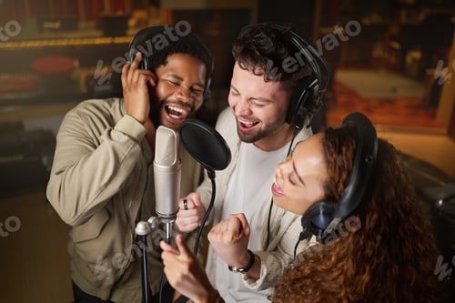 Preview: Music, streaming and diversity, band recording in studio singing into microphone with headphones an