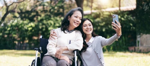Preview: Senior on wheelchair and daughter family, Young asian woman embracing and selfie on smartphone