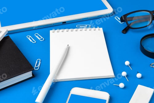 Preview: Flat lay, top view of blue office table desk. Workspace with blank note book, office supplies