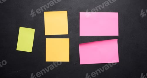 Preview: Multicolored paper stickers on a black chalkboard, space for notes and labels