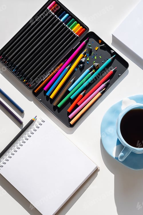Preview: Creative Workspace With Colored Pencils and Blank Artist Block. Art Therapy for Mental Wellbeing.