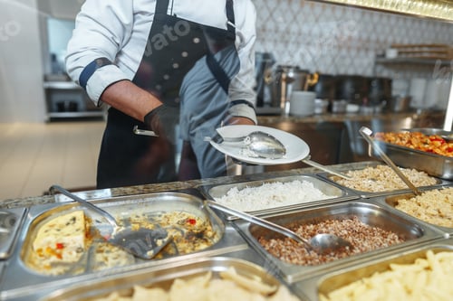 Preview: Chef Serving Freshly Cooked Dishes at a Restaurant Buffet During Lunchtime