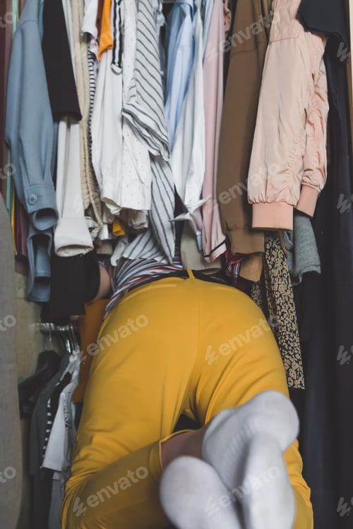 Preview: Spring cleaning,Fast fashion, the girl puts things in order in the closet. A bunch of colorful