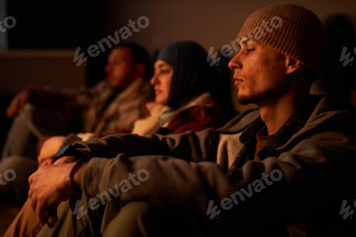 Preview: Group of Middle Eastern people hiding in dark bomb shelter