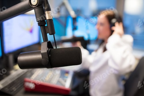 Preview: Studio Microphone in Radio Station with Female Host In Background
