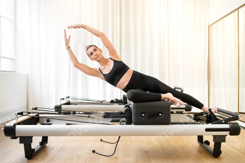 Preview: Woman performing a pilates yoga mermaid exercise