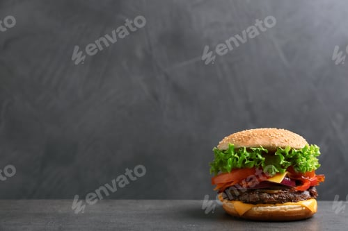 Preview: Tasty burger with bacon on table against grey background, space for text