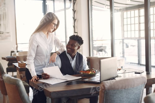 Preview: Stylish people working in a office and use the laptop
