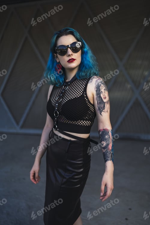 Preview: European female with tattoo and blue hair wearing sunglasses and sexy black dress posing
