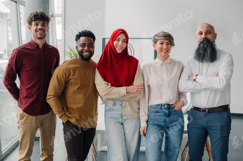 Preview: Startup team of diverse people smiling in office