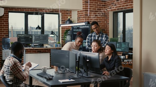 Preview: Software engineers brainstorming ideas looking at code on computer screens asking feedback