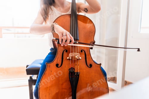 Preview: Talented Young Cellist Practicing at Home for Upcoming Concert