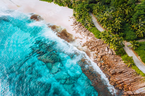 Preview: Aerial photo of ocean waves hitting rocky coastline of beautiful paradise dream tropical beach at