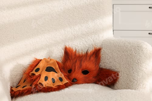 Preview: Quadrobics. Fox mask, gloves and tail on armchair indoors