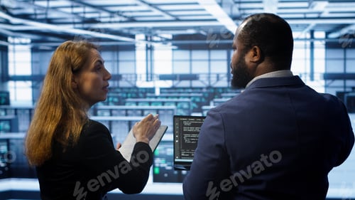 Preview: Teamworking programmers in data center overseeing server operations