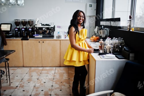 Preview: Stylish african american woman at yellow dress
